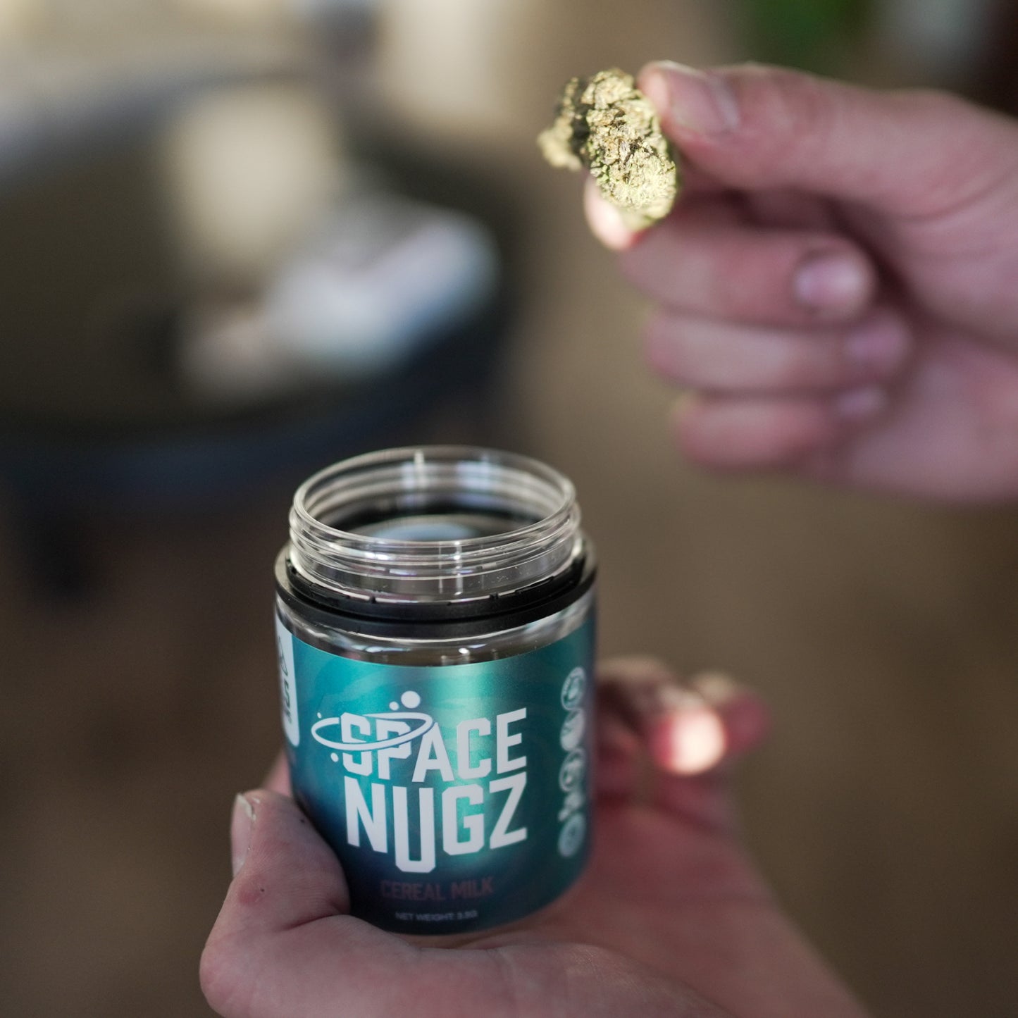 Cereal Milk THCA Flower - Hybrid Flower Strain - Man Holding Jar and Flower Nug - Galaxy Treats in the U.S.