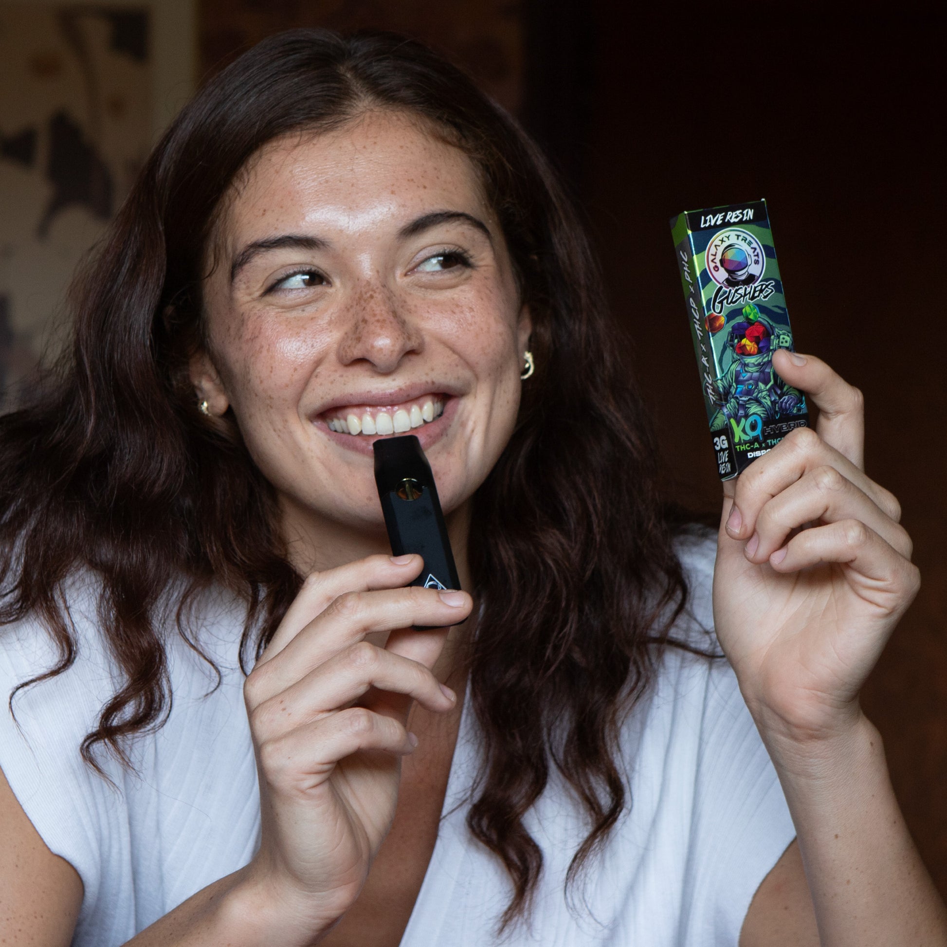 Gushers Vape Pen - Live Resin Hybrid - Smiling Woman Holding Vape Device - Galaxy Treats in the U.S.