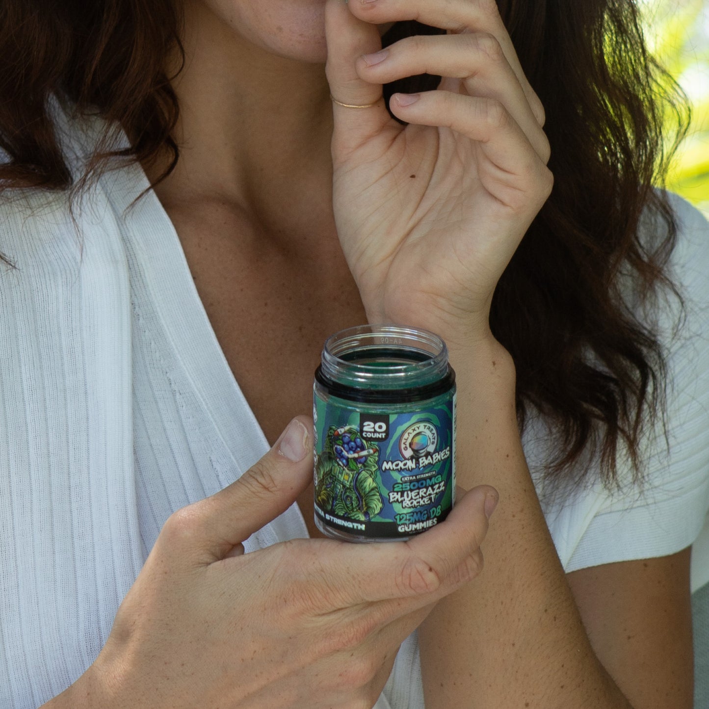 Bluerazz Rocket Extra Strength Delta 8 Gummies - 125MG Delta 8 Edible - Woman Holding Gummy Jar - Galaxy Treats in the U.S.