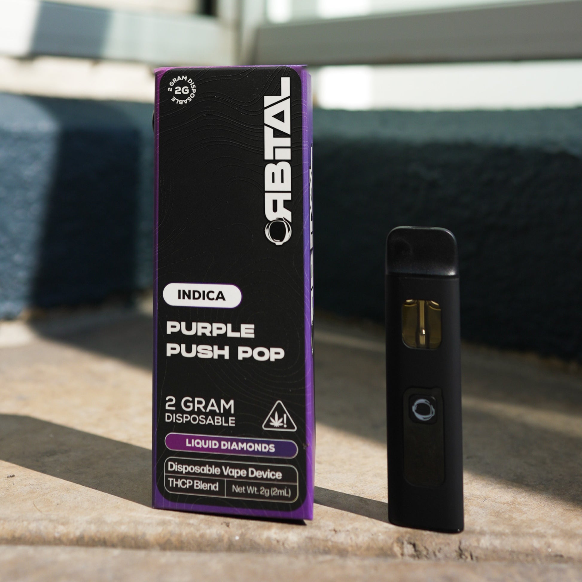 Purple Push Pop Vape - Orbital 2G Sativa Disposable - THCP Liquid Diamonds - Front Shot of Packaging Box and Device - Galaxy Treats in the U.S.
