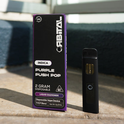 Purple Push Pop Vape - Orbital 2G Sativa Disposable - THCP Liquid Diamonds - Front Shot of Packaging Box and Device - Galaxy Treats in the U.S.