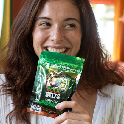 Chile Lime Watermelon Sour Belts - High Potency 300MG THC Edibles - Woman Smiling Holding Packaging in Hand - Galaxy Treats in the U.S.