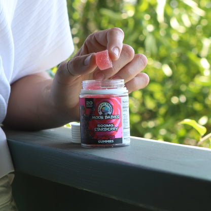 Starberry Delta 8 Gummies - 25MG Delta 8 Strawberry Edibles - Image of Holding Gummy - Galaxy Treats in the U.S.
