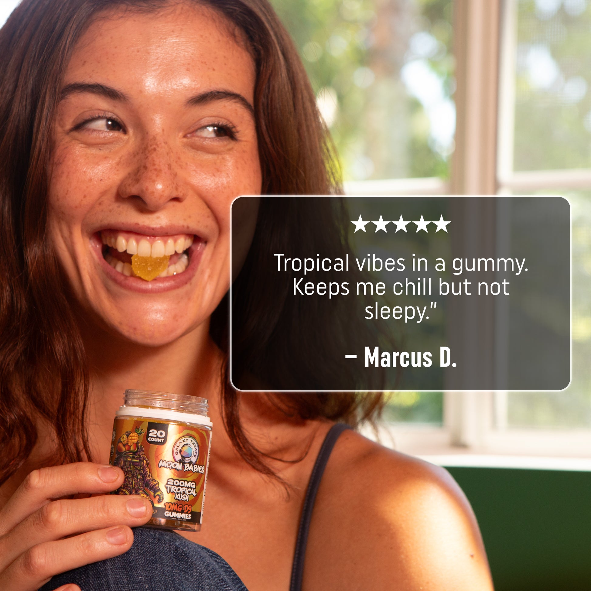 Tropical Kush Delta 9 Gummies - 10MG Delta 9 - Smiling Woman Eating Gummy - 5 Star Review - Galaxy Treats in the U.S.