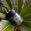 Green Crack THCA Flower - Sativa Flower Strain - Creative Shot of Jar On Plant - Galaxy Treats in the U.S.