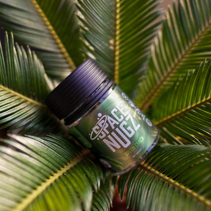 Green Crack THCA Flower - Sativa Flower Strain - Creative Shot of Jar On Plant - Galaxy Treats in the U.S.