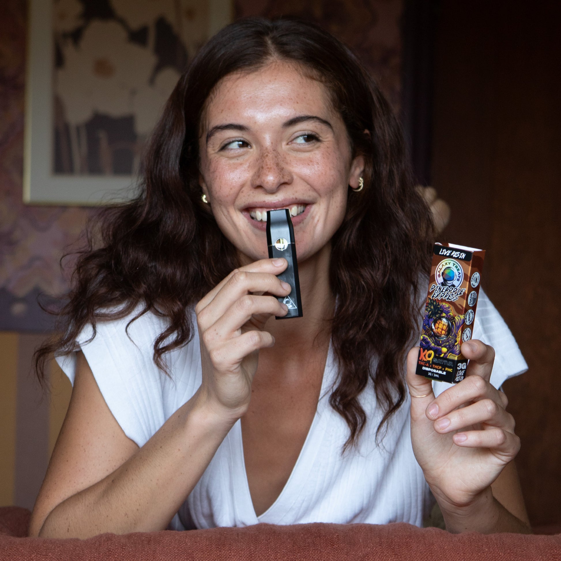 Pineapple Express Vape Pen - Live Resin Sativa - Smiling Woman Holding Vape Device - Galaxy Treats in the U.S.