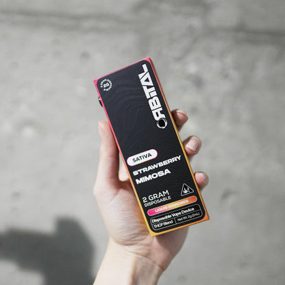 Strawberry Mimosa Vape - Orbital 2G Sativa Disposable - THCP Liquid Diamonds - Front Shot of Hand Holding Packaging Box - Galaxy Treats in the U.S.